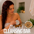 Grace and Glade - Ritual I Cleansing Shampoo Bar - Image shows  woman with wet red color treated hair holding a ritual one shampoo bar, placing it on a wood soap rack for drying.