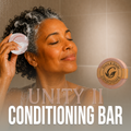 Grace and Glade - Unity II Conditioning Bar - Image shows woman enjoying conditioning her grey and black coil hair. 