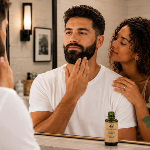 Man with a beard touching his chin in front of a mirror, with a woman standing beside him and a bottle of oil on the counter.